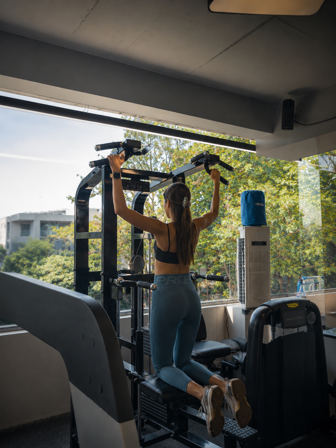 Personal training session with coach spotting client on bench press, intimate premium studio, low-key dark lighting