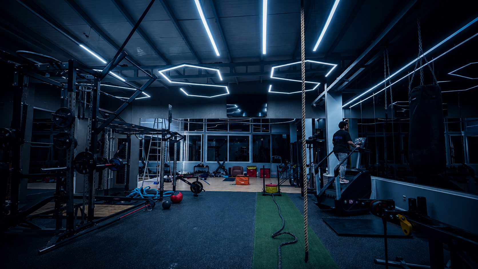 Premium gym locker room with clean white tiles, warm lighting, wooden accents, luxury changing area