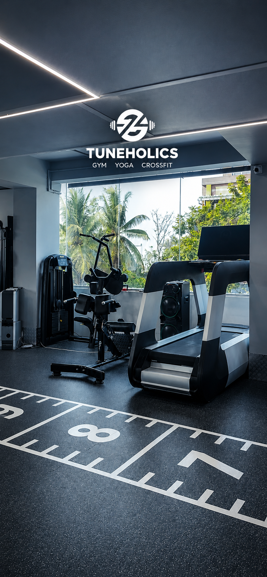 Weight room with dumbbells racked on wall, moody amber lighting, dark painted walls, premium rubber flooring